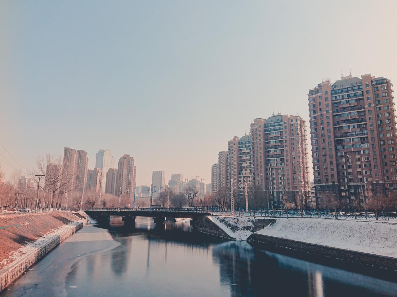 body of water near city buildings during daytime