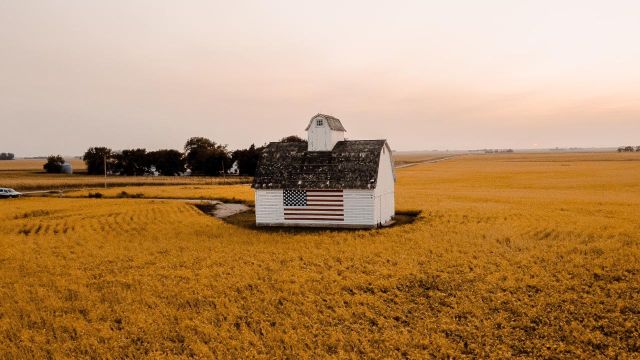 white and black house on brown field under white sky during daytime